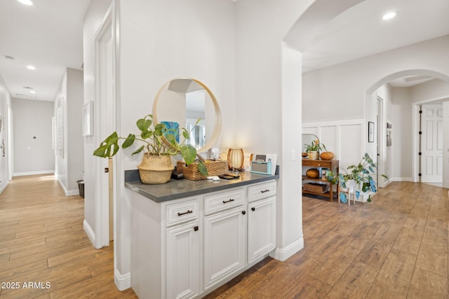3917 E Patrick Ln, Phoenix, AZ 85050 - hallway featuring arched walkways, light wood finished floors, and recessed lighting