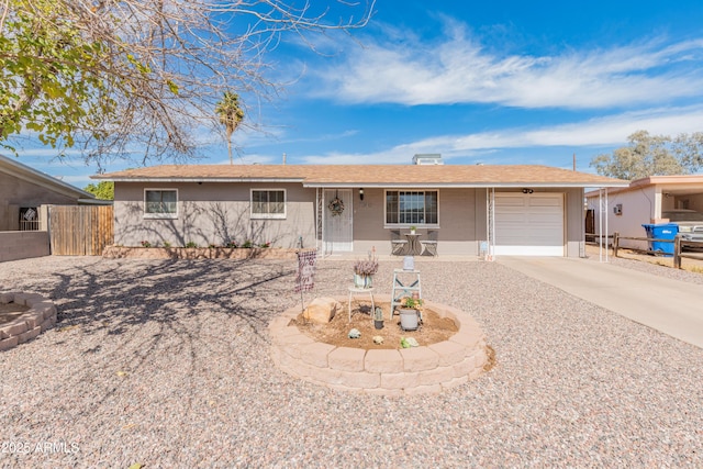 single story home featuring a garage, fence, and concrete driveway