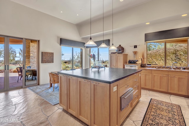 kitchen with hanging light fixtures, a center island, and sink