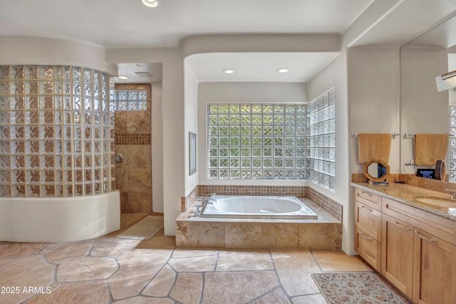 bathroom featuring vanity and separate shower and tub