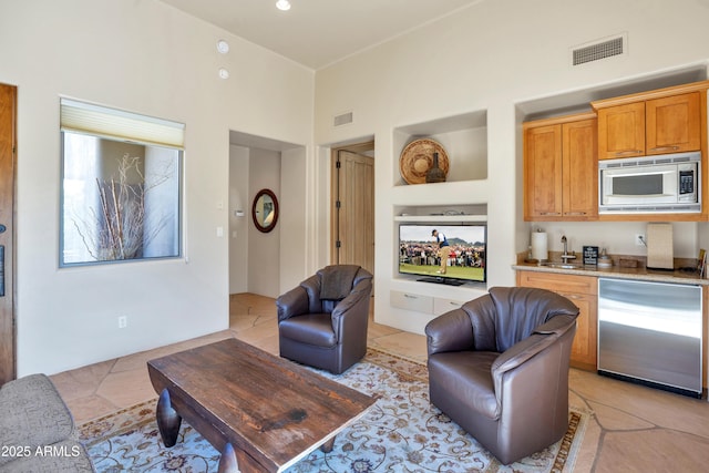 tiled living room featuring sink