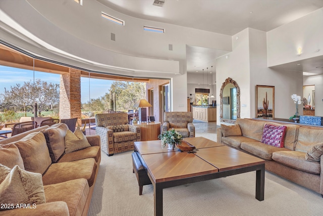 carpeted living room with a high ceiling