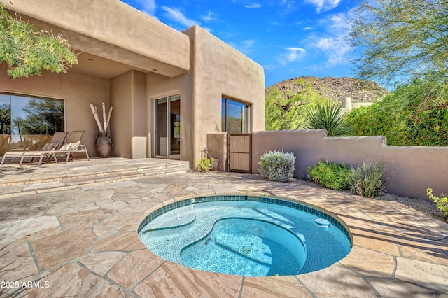 view of swimming pool with a mountain view and a patio area