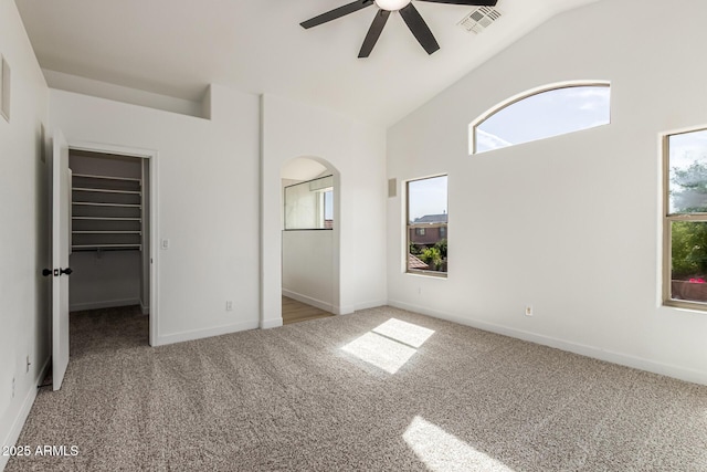 2112 S 160th Dr, Goodyear, AZ 85338 - unfurnished bedroom featuring carpet floors, vaulted ceiling, multiple windows, and a walk in closet