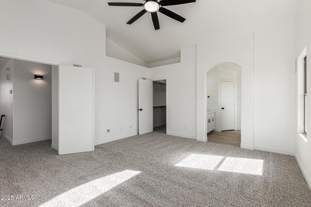 2112 S 160th Dr, Goodyear, AZ 85338 - unfurnished bedroom with light colored carpet, arched walkways, high vaulted ceiling, a spacious closet, and a ceiling fan