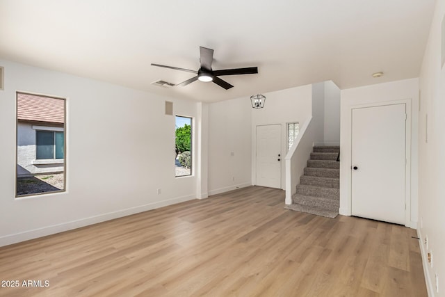2112 S 160th Dr, Goodyear, AZ 85338 - unfurnished living room with light wood-style floors, stairs, and ceiling fan