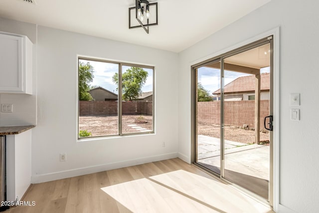 2112 S 160th Dr, Goodyear, AZ 85338 - unfurnished dining area with healthy amount of natural light and light wood-type flooring