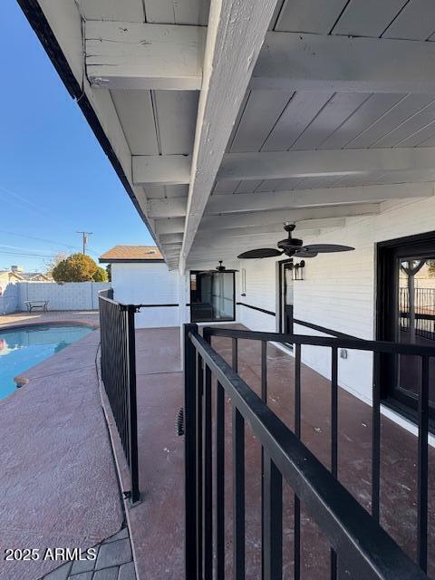 view of patio / terrace with a fenced in pool and ceiling fan