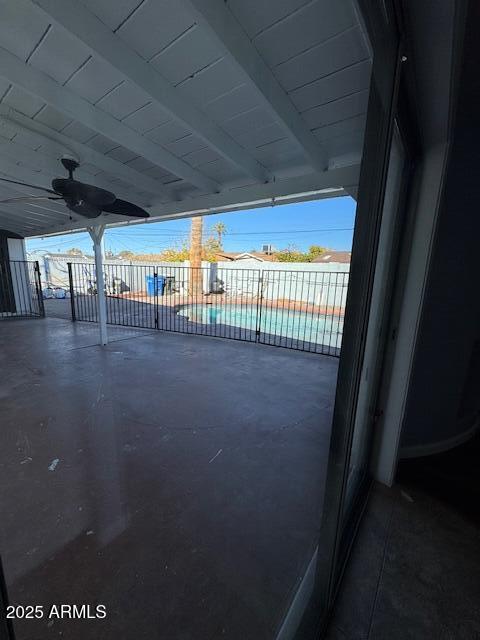 view of patio with ceiling fan and a fenced in pool