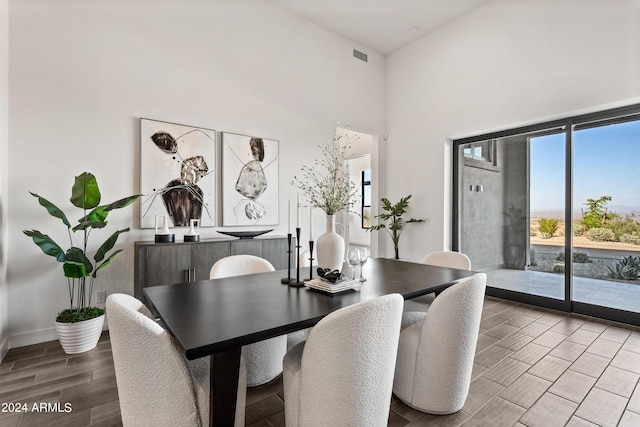 dining room featuring a towering ceiling