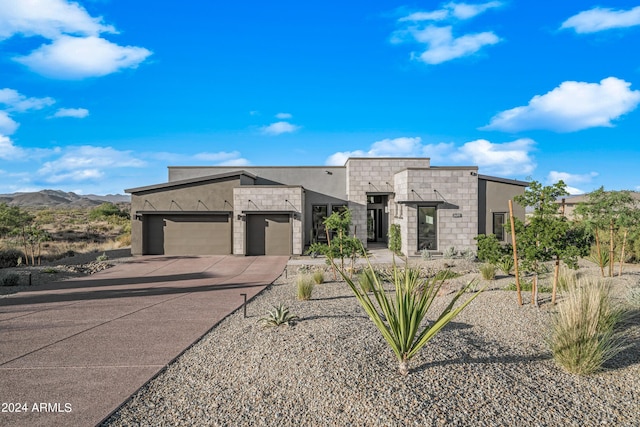 contemporary home with a mountain view and a garage