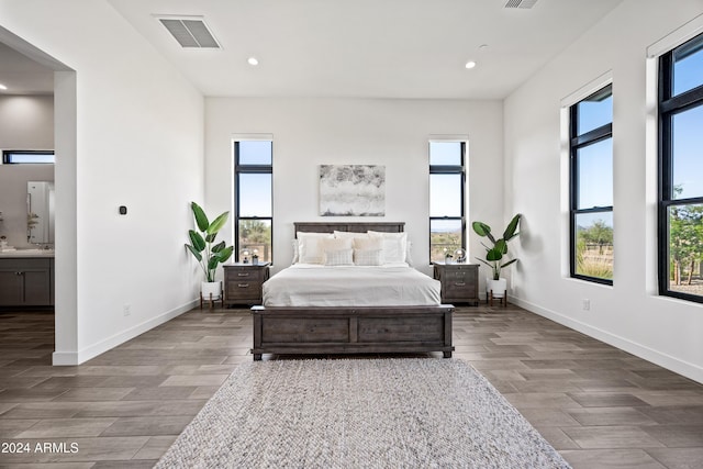 bedroom with multiple windows and ensuite bath