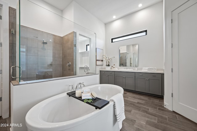 bathroom with vanity and independent shower and bath