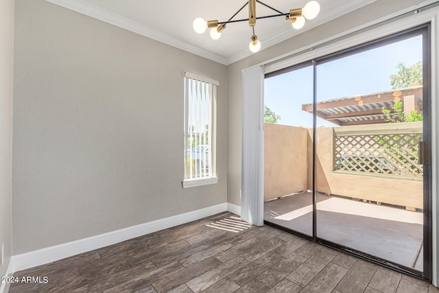 unfurnished room featuring a notable chandelier, crown molding, and hardwood / wood-style flooring