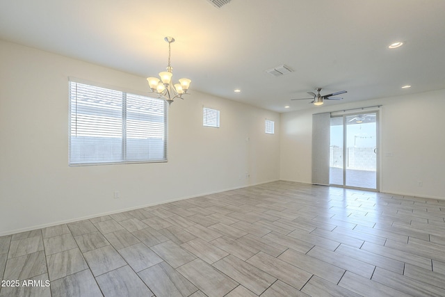 unfurnished room featuring ceiling fan with notable chandelier