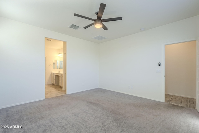 unfurnished room with ceiling fan and light colored carpet