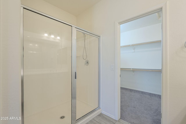 bathroom with a shower with shower door