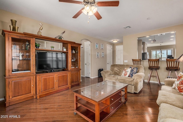 living room with dark hardwood / wood-style flooring and ceiling fan