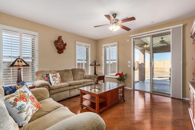 living room featuring a healthy amount of sunlight, ceiling fan, and dark hardwood / wood-style floors