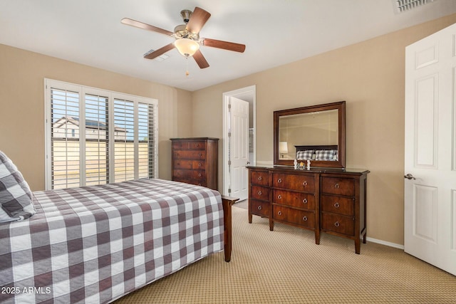 bedroom featuring ceiling fan and light carpet