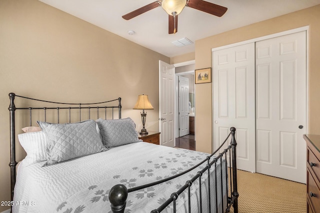 carpeted bedroom with ceiling fan and a closet