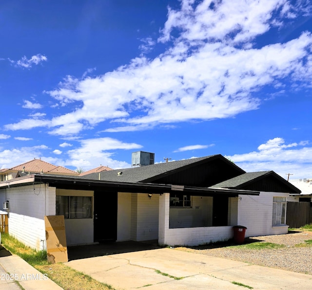 1432 S Stanley Pl, Tempe, AZ 85281 - view of front facade featuring cooling unit, a shingled roof, and fence