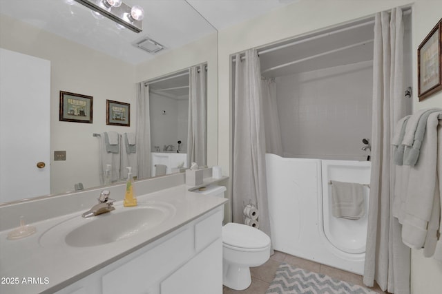 bathroom featuring tile patterned flooring, vanity, and toilet