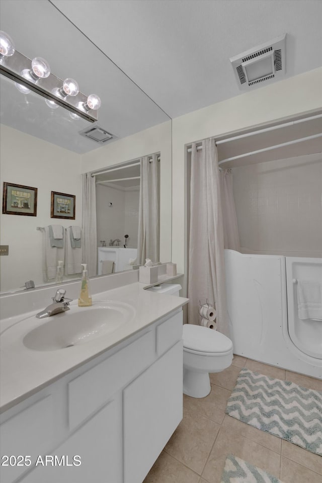 bathroom featuring tile patterned flooring, vanity, and toilet