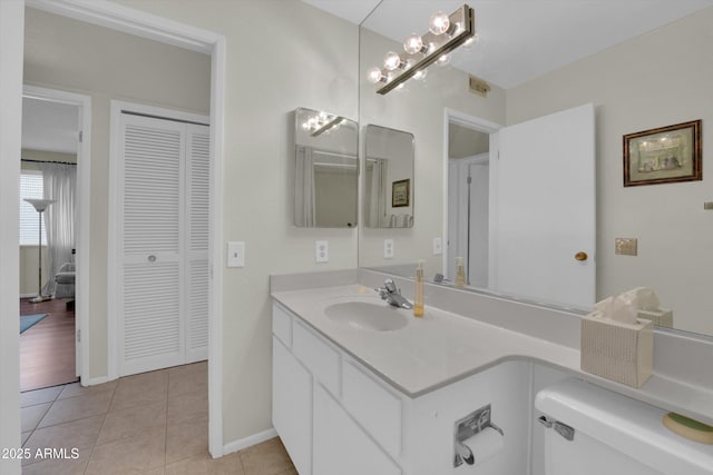 bathroom with tile patterned flooring, vanity, and toilet