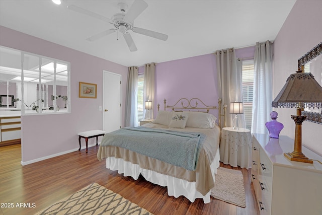 bedroom with ceiling fan and light hardwood / wood-style flooring