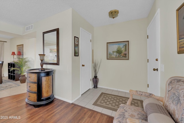 entrance foyer featuring light tile patterned flooring and a textured ceiling