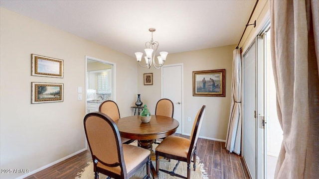 10506 W Desert Forest Cir, Sun City, AZ 85351 - dining area featuring dark wood-style flooring, a chandelier, and baseboards