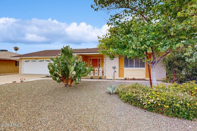 10506 W Desert Forest Cir, Sun City, AZ 85351 - view of front of property with driveway, a garage, brick siding, and a porch
