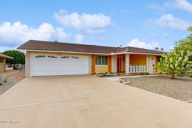 10506 W Desert Forest Cir, Sun City, AZ 85351 - single story home featuring concrete driveway, brick siding, a garage, and covered porch