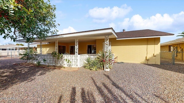 10506 W Desert Forest Cir, Sun City, AZ 85351 - view of front of property featuring covered porch, fence, and a gate