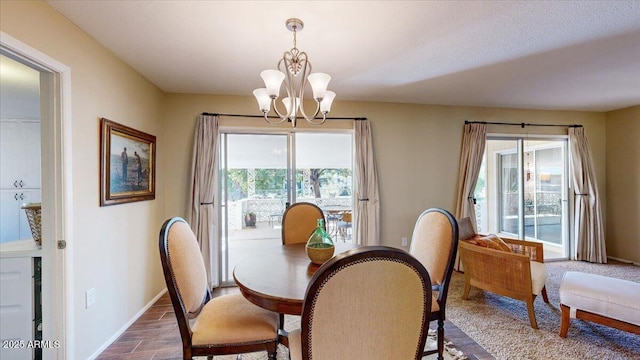 10506 W Desert Forest Cir, Sun City, AZ 85351 - dining room with a chandelier and baseboards