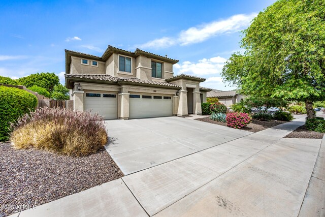 19242 W Pasadena Ave, Litchfield Park, AZ 85340 - mediterranean / spanish-style home with an attached garage, stucco siding, driveway, and a tile roof