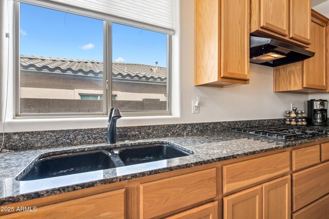 19242 W Pasadena Ave, Litchfield Park, AZ 85340 - kitchen featuring under cabinet range hood, a sink, gas stovetop, and dark stone countertops