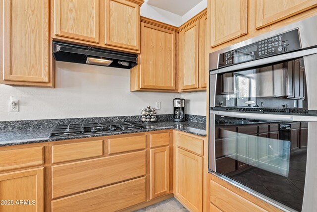 19242 W Pasadena Ave, Litchfield Park, AZ 85340 - kitchen with stainless steel double oven, ventilation hood, light brown cabinetry, black gas stovetop, and dark stone countertops