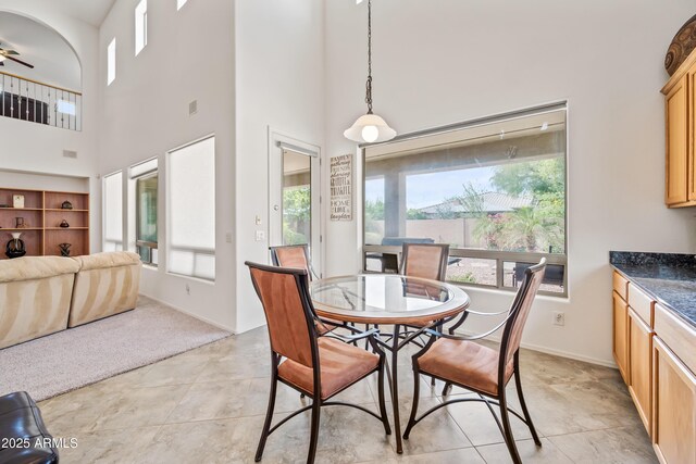 19242 W Pasadena Ave, Litchfield Park, AZ 85340 - dining area featuring a towering ceiling, plenty of natural light, ceiling fan, and light tile patterned flooring
