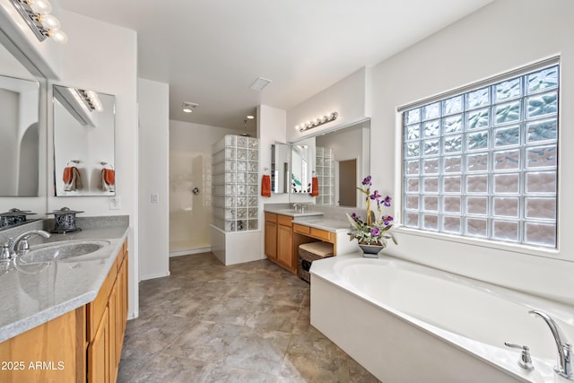19242 W Pasadena Ave, Litchfield Park, AZ 85340 - full bathroom with healthy amount of natural light, a bath, a walk in shower, and two vanities