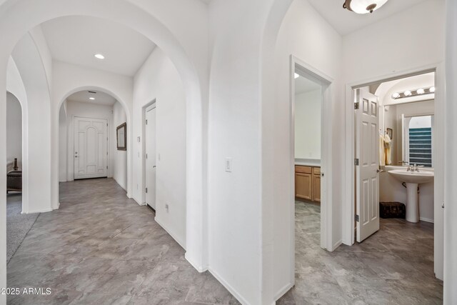 19242 W Pasadena Ave, Litchfield Park, AZ 85340 - hall with arched walkways, baseboards, and recessed lighting