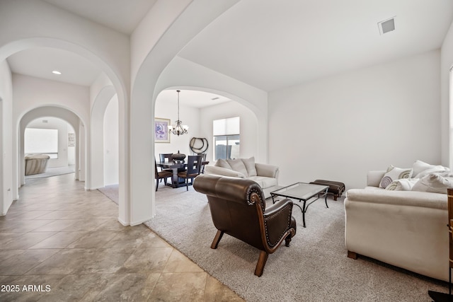 19242 W Pasadena Ave, Litchfield Park, AZ 85340 - living room with arched walkways and a chandelier