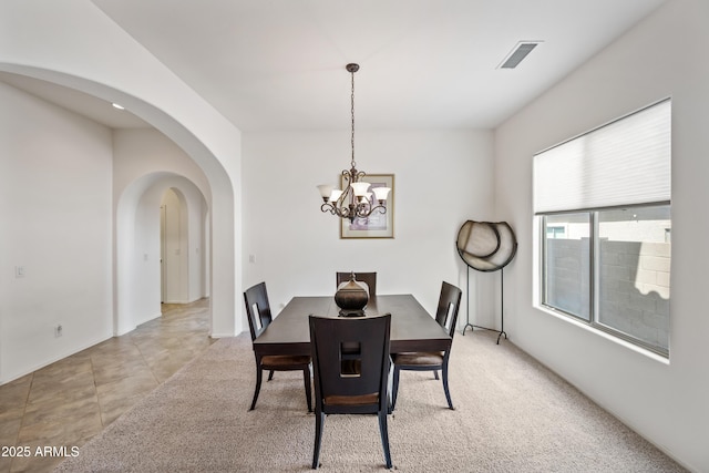 19242 W Pasadena Ave, Litchfield Park, AZ 85340 - dining room featuring arched walkways and a chandelier