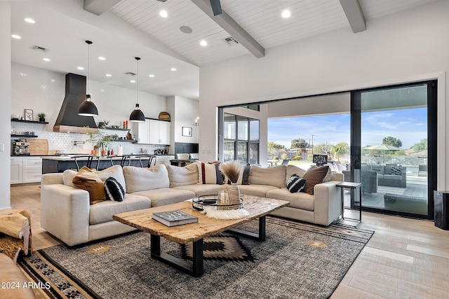 living room featuring beam ceiling, high vaulted ceiling, light hardwood / wood-style floors, and wooden ceiling