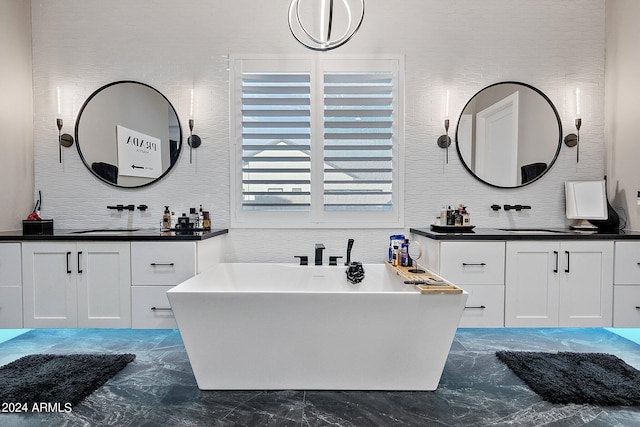 bathroom featuring vanity and a tub to relax in