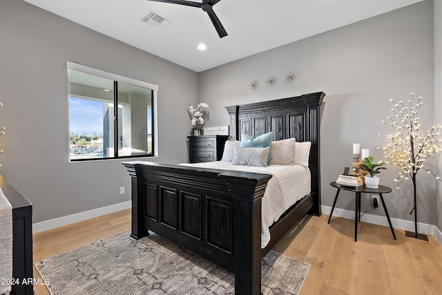 bedroom with ceiling fan and light hardwood / wood-style flooring