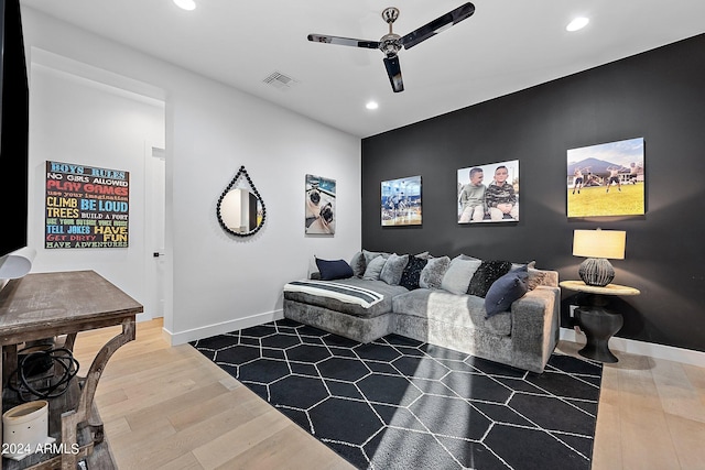 living room with ceiling fan and hardwood / wood-style floors