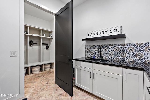 mudroom with light parquet floors and sink