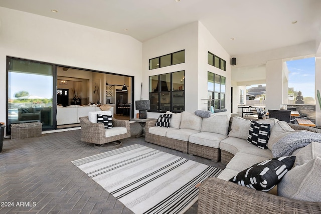 living room with high vaulted ceiling